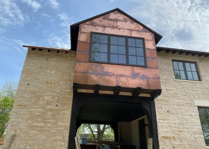 Copper metal panel facade on a stone building for Metal Roof Coating in West Des Moines